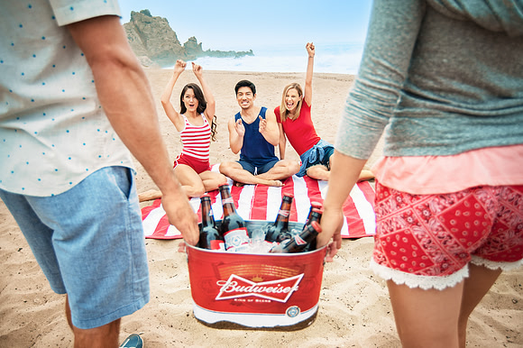 Friends Gathering Around Beach Cooler