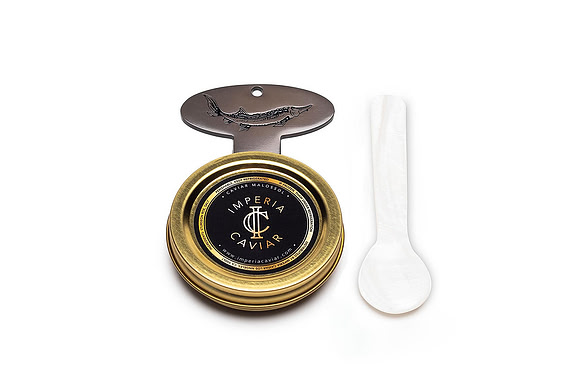 White-background product photograph of an open gold Imperia Caviar tin filled with caviar.