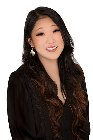 Clean studio headshot of a woman in black against a white background.