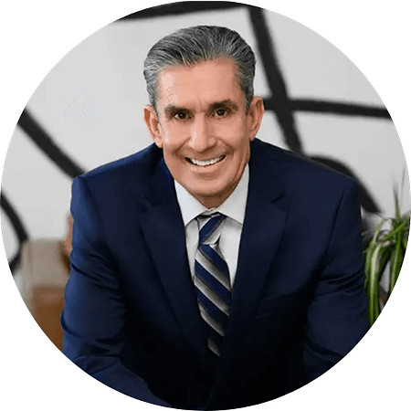 Professional branding portrait of business consultant and leadership coach Sean Caughron in a navy suit.