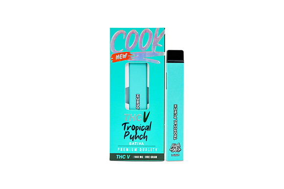 White-background product photograph of a turquoise Cook disposable vape beside Tropical Punch packaging.