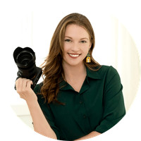 Professional branding portrait of a photographer holding a camera, created for the Ashley Blackmer Photography website project.