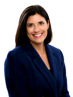 Clean studio business headshot of a woman in a dark blue blazer against a white background.