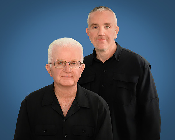 Professional branding portrait of the two W&W Painting Contractors business owners against a blue background.